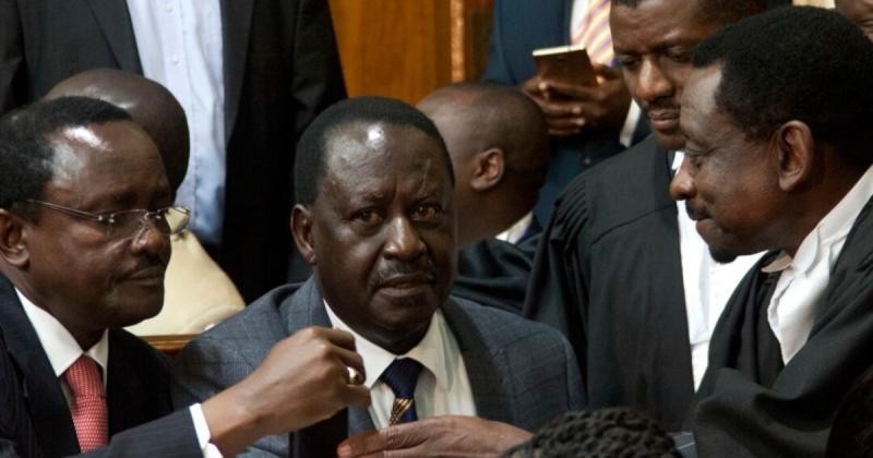 Azimio La Umoja principals Raila Odinga and Kalonzo Musyoka consulting with their lawyers.